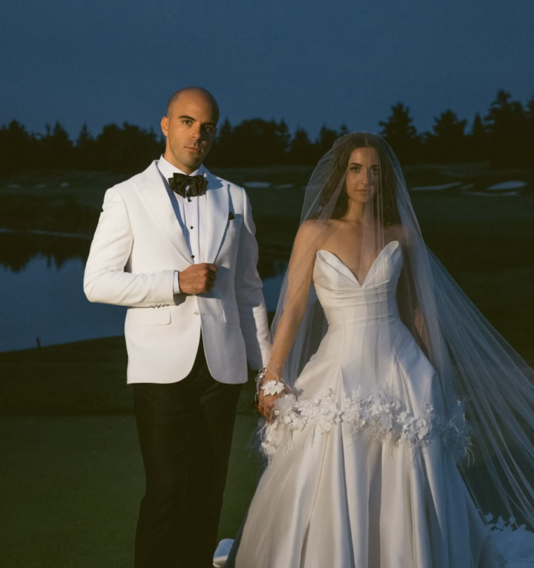 Wedding couple by the water at dusk