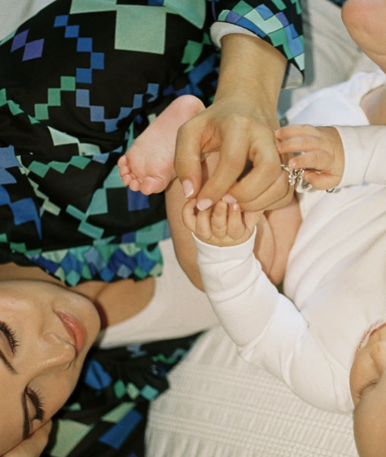 A close-up of a family holding hands